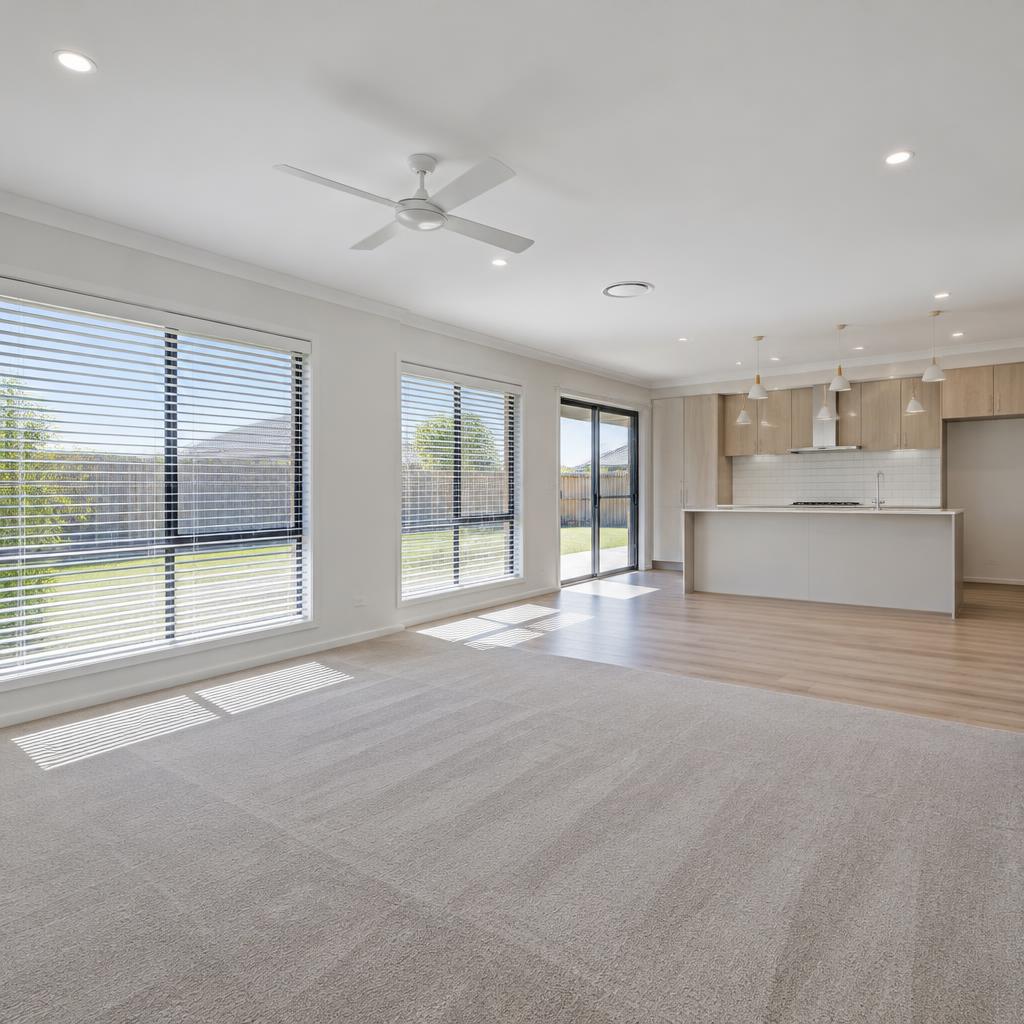 Bright, move-in-ready living area with floor coverings and window blinds